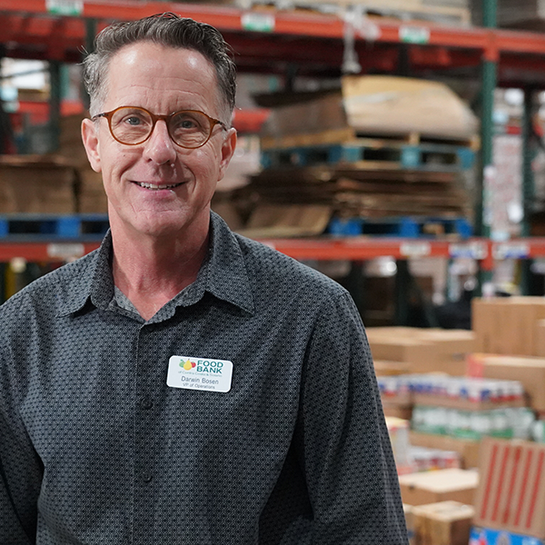 A man in glasses stands in our Concord warehouse.