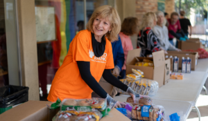 A volunteer distributes bread for the Food Bank.