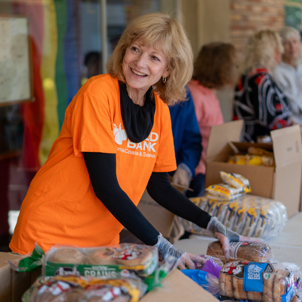 A volunteer distributes bread for the Food Bank.